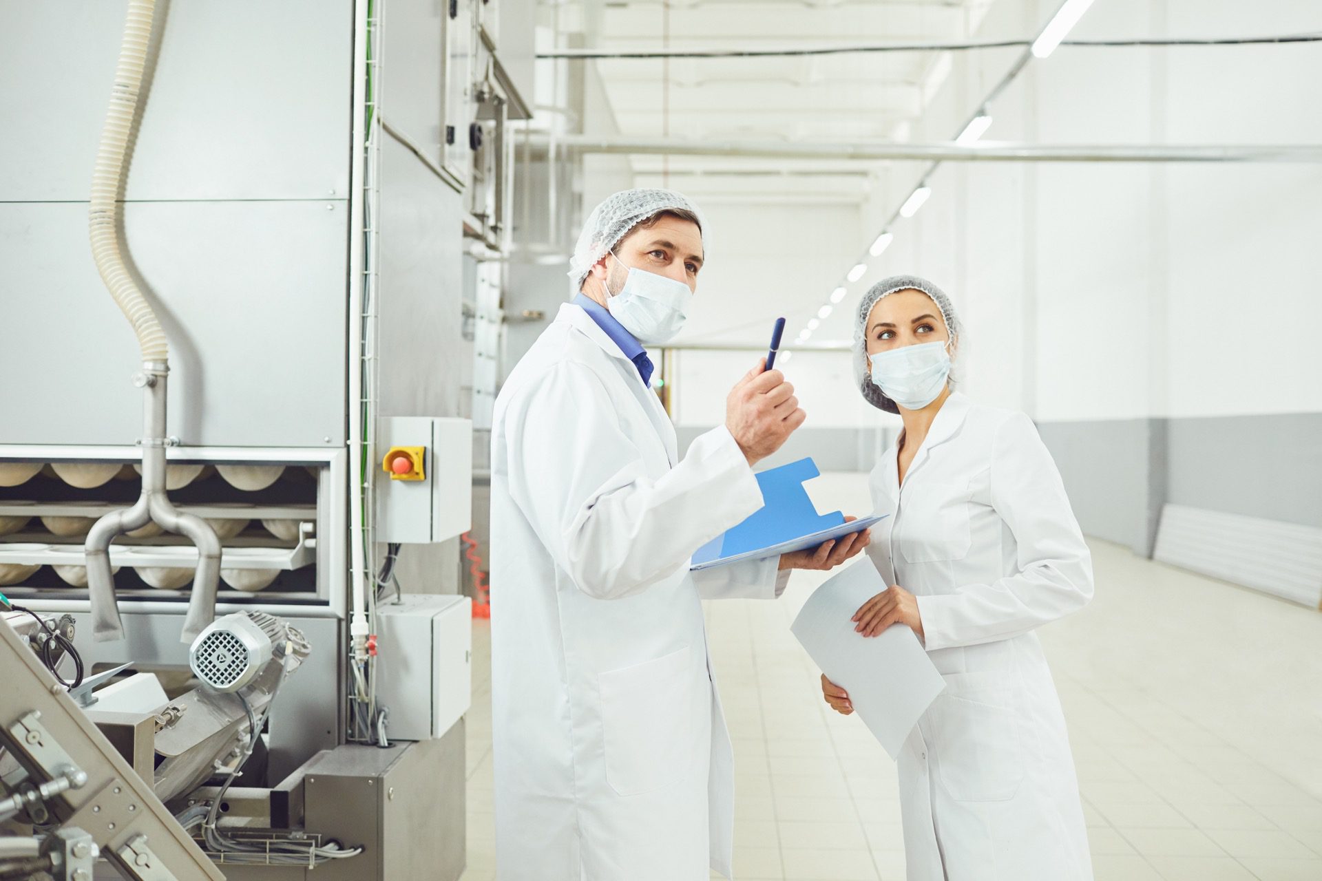 Food inspection officer pointing out update in food factory